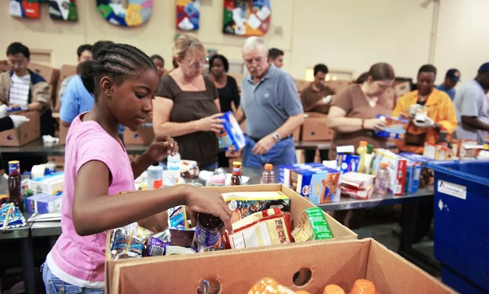Volunteers and families working together at food bank